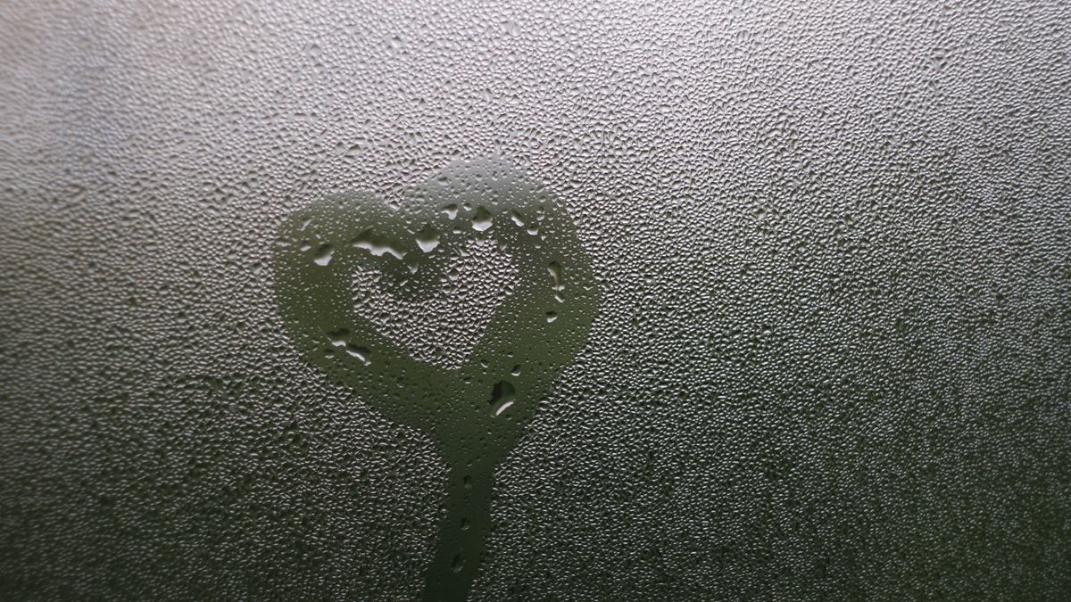 Heart drawn in condensation on a window.
